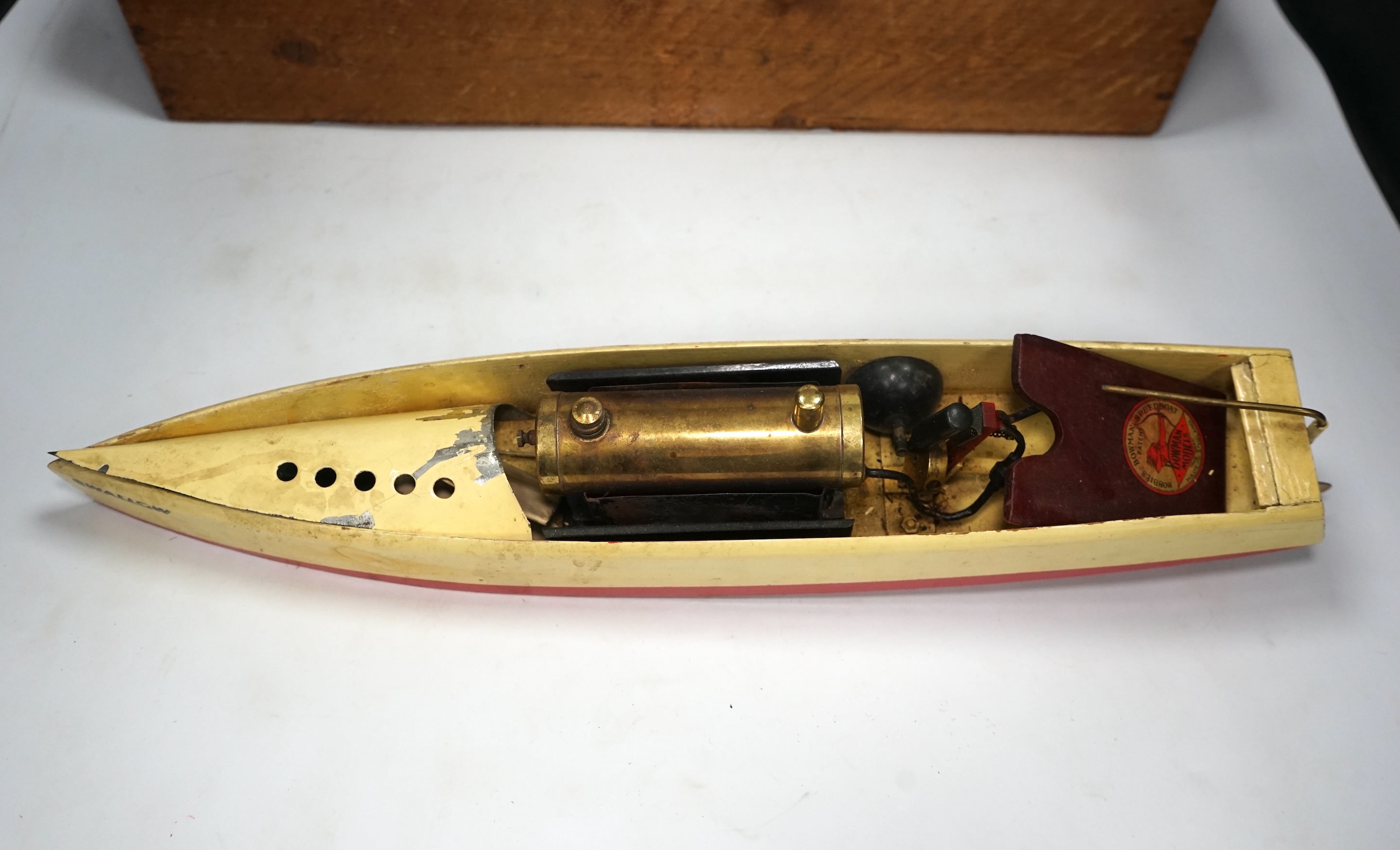 A 1930s wooden boxed Bowman Models live steam speedboat; ‘Swallow’, of wood and tinplate construction, hull 49cm long. Condition - fair.